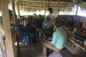 Meaghan showing and talking about the artifacts found during surface collection in the settlement
